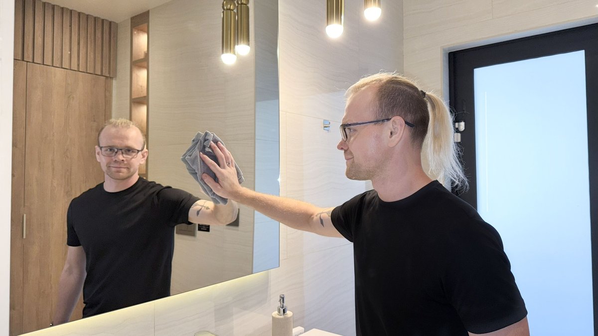 Cleaning a bathroom mirror in Hollywood, FL