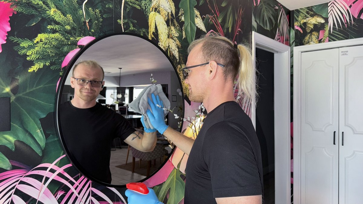 Wiping a round mirror — residential cleaning